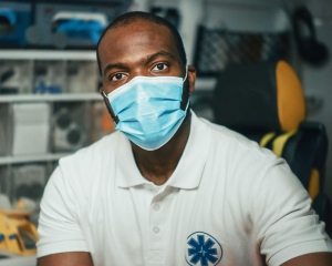 EMT wearing a mask looking at camera