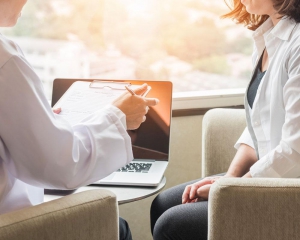 Doctor reviewing papers with patient